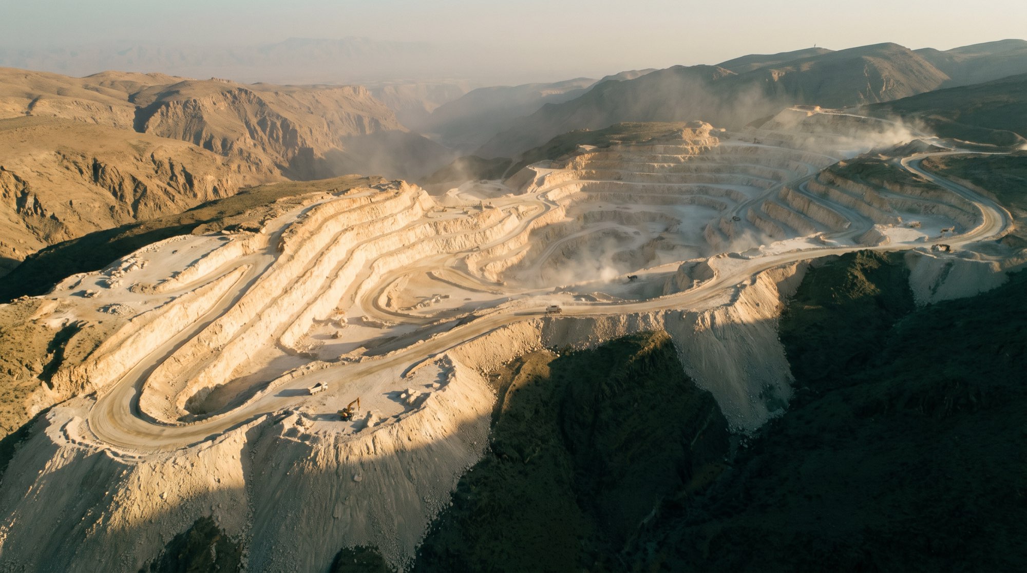 Working limestone quarry in the Hajar mountains at golden hour